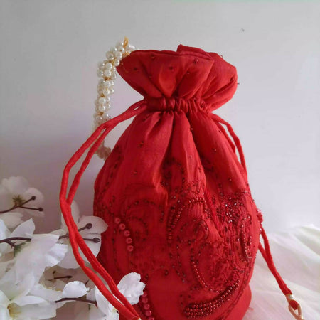 PEARL EMBELLISHED RED ROUND POTLI BAG WITH PEARL HANDLE