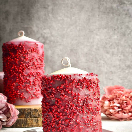 Pillar candle with red dried flowers